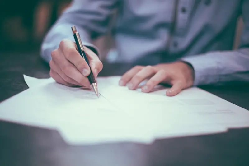 Signing closing documents at an Alabama real estate closing
