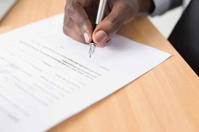 Veteran signing home purchase documents